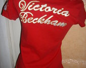 Victoria Becham raudona maikute 