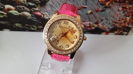 Moteriškas laikrodis su kristalais.
